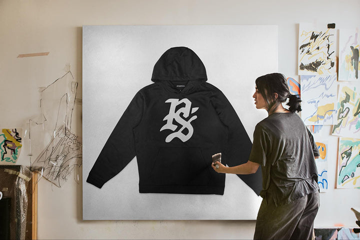 hoodie mockup being painted by woman on canvas